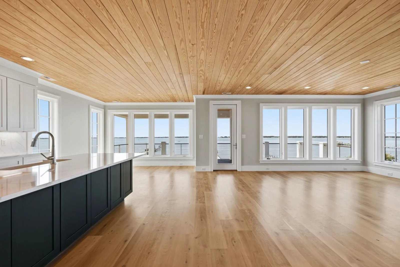 Great room with walls of windows to the water
